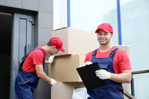 Team safely carrying furniture during flat removals in Waddon