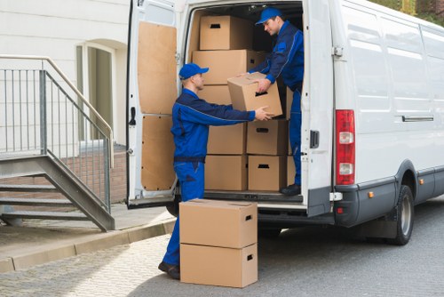 Packed moving boxes and furniture ready for flat removals in Waddon